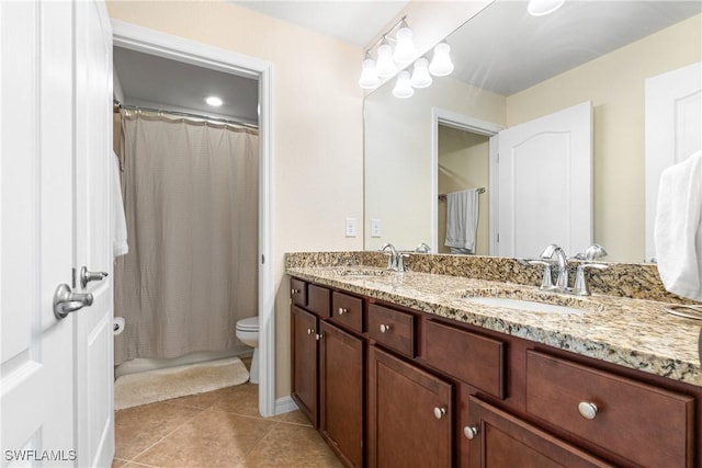 bathroom featuring toilet, tile patterned flooring, and vanity