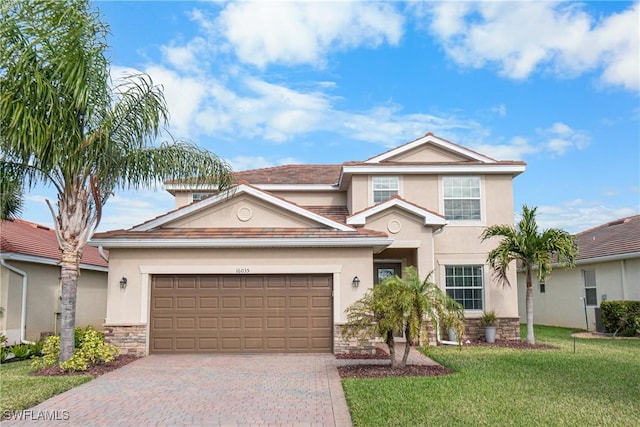 view of front property featuring a front yard and a garage