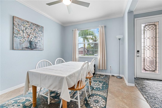 tiled dining area with ceiling fan and ornamental molding