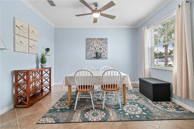 dining area featuring ceiling fan, light tile patterned flooring, and crown molding