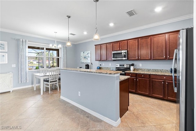 kitchen featuring appliances with stainless steel finishes, an inviting chandelier, hanging light fixtures, a kitchen island with sink, and light stone counters