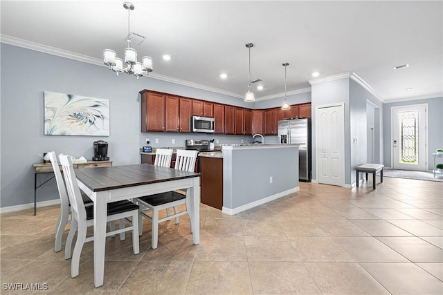 kitchen featuring stainless steel appliances, pendant lighting, and ornamental molding