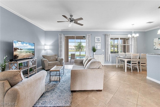 tiled living room featuring ornamental molding, a healthy amount of sunlight, and ceiling fan with notable chandelier