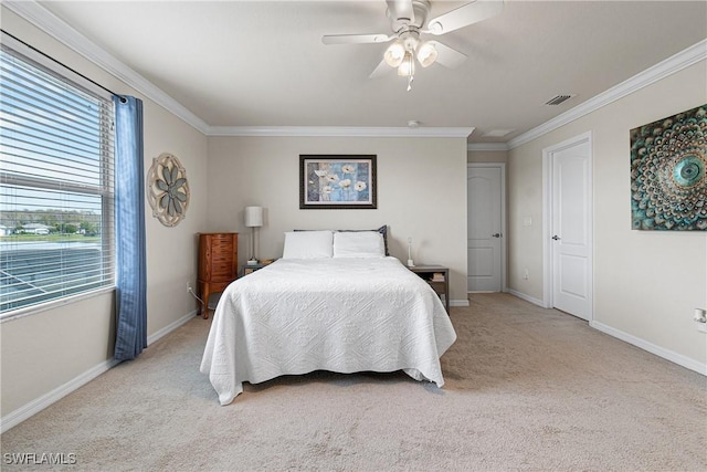 carpeted bedroom featuring ceiling fan and crown molding