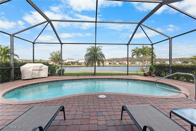 view of swimming pool with a water view, a patio area, a grill, and glass enclosure