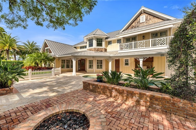 rear view of property featuring a balcony