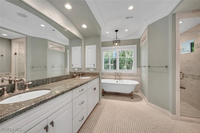 bathroom featuring tile patterned flooring, vanity, crown molding, and separate shower and tub