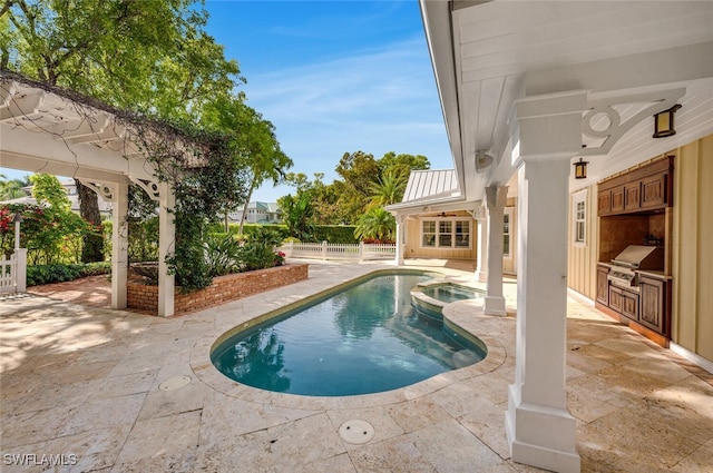 view of pool with an in ground hot tub, an outdoor kitchen, grilling area, and a patio area