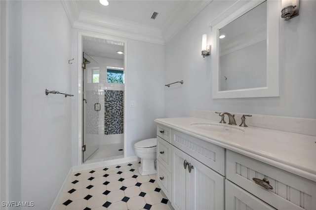 bathroom featuring crown molding, vanity, toilet, and a shower with shower door