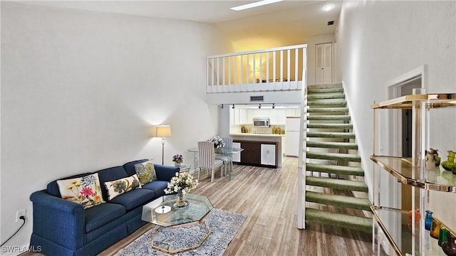 living room featuring hardwood / wood-style floors and a high ceiling