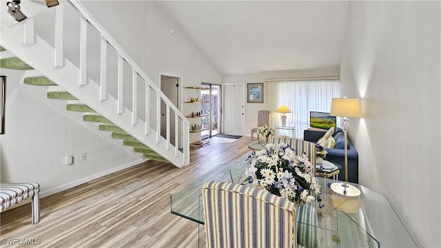 interior space with hardwood / wood-style floors and high vaulted ceiling