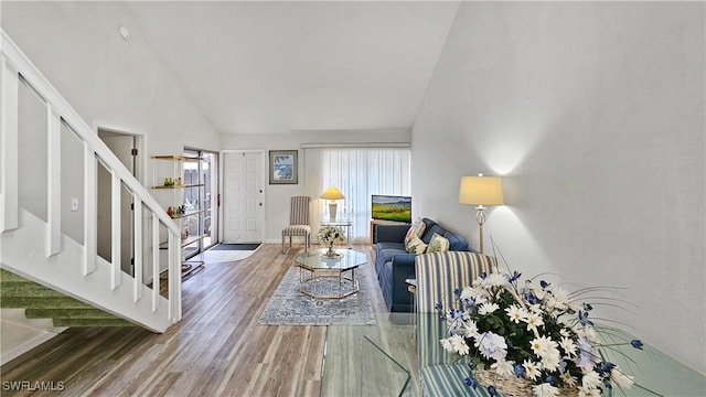 living room featuring hardwood / wood-style flooring and high vaulted ceiling