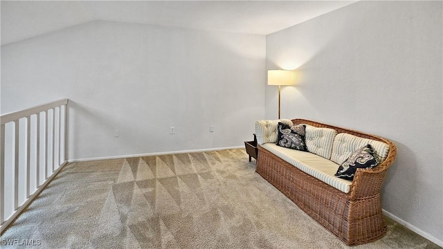 sitting room with vaulted ceiling and carpet floors