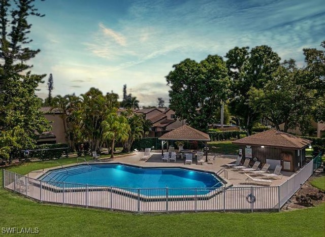 view of pool featuring a yard, a gazebo, and a patio