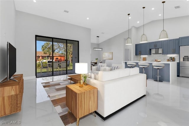 living room with high vaulted ceiling