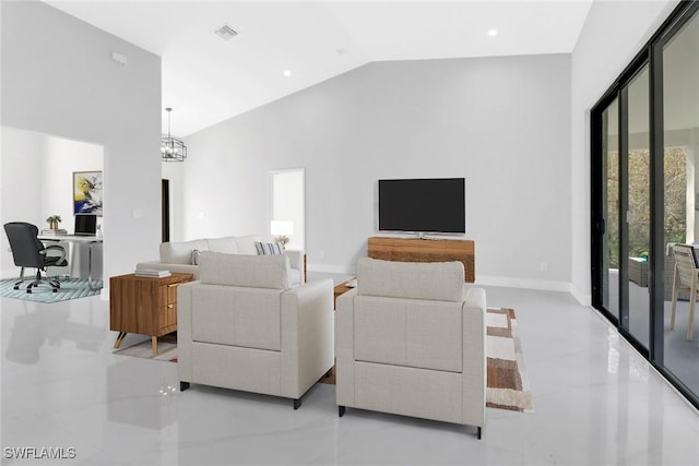 living room featuring an inviting chandelier and high vaulted ceiling