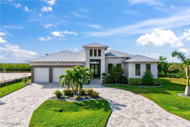 view of front facade with a garage and a front lawn