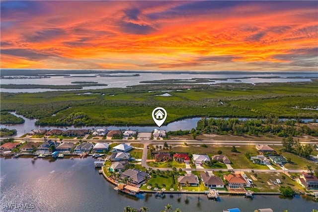 aerial view at dusk with a water view