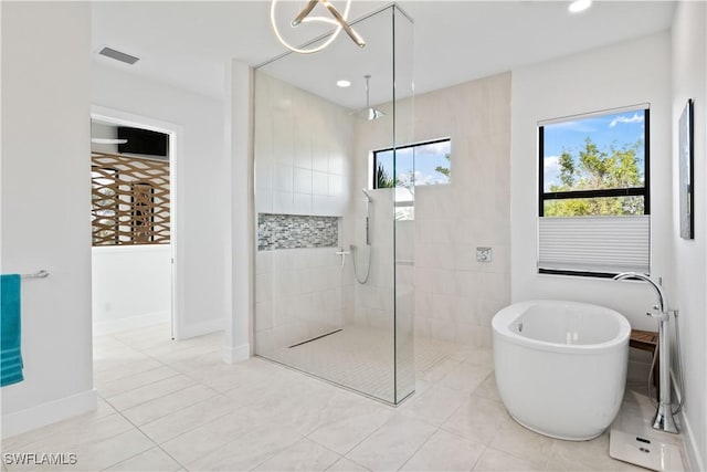 bathroom with independent shower and bath and a wealth of natural light