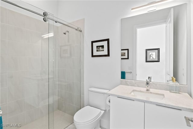 bathroom featuring vanity, toilet, and an enclosed shower