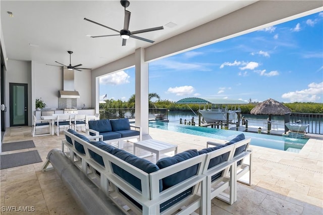 view of patio / terrace featuring an outdoor hangout area, pool water feature, ceiling fan, and a water view