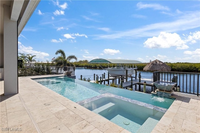 view of pool with a water view, a boat dock, and an in ground hot tub