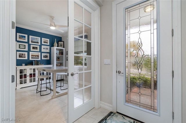 entryway featuring light tile patterned flooring, ceiling fan, ornamental molding, and french doors