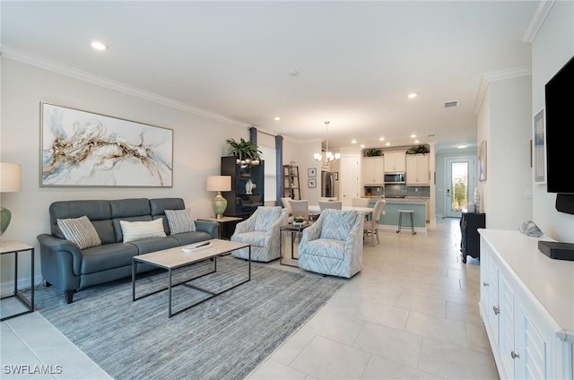 tiled living room featuring a notable chandelier and ornamental molding