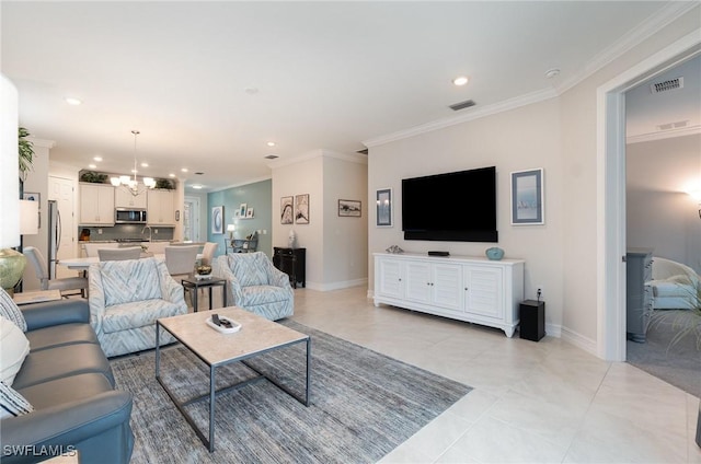 living room with a notable chandelier, crown molding, sink, and light tile patterned floors