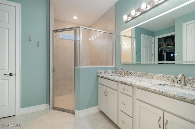 bathroom with vanity, tile patterned floors, and walk in shower