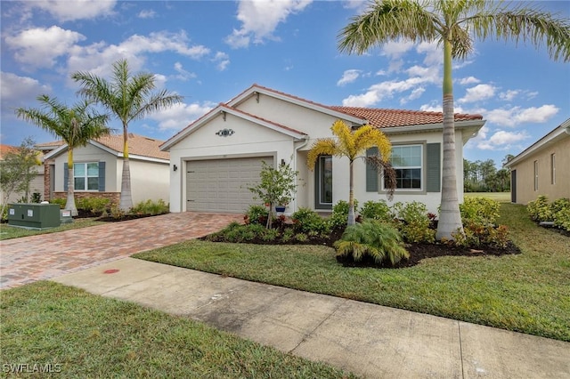 view of front of property with a garage and a front lawn