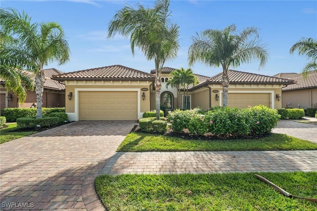 mediterranean / spanish-style house with a garage