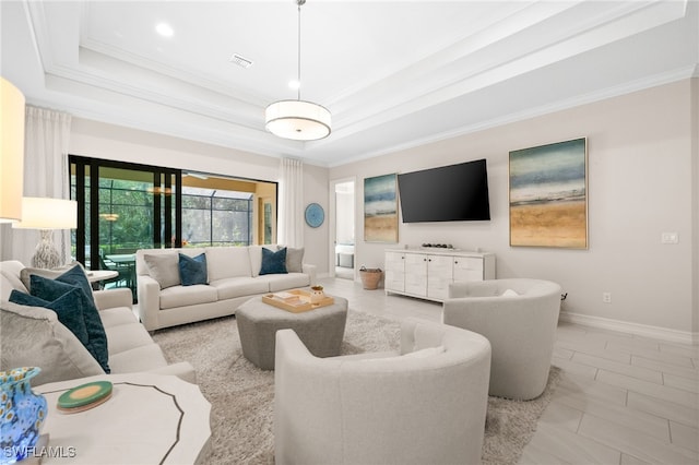 living room featuring crown molding and a raised ceiling