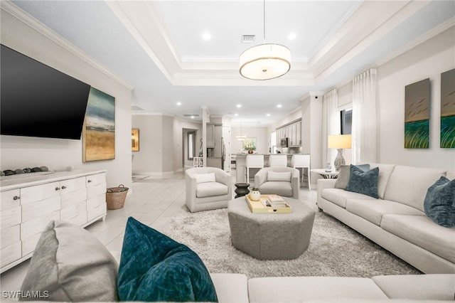 living room featuring light tile patterned floors, crown molding, and a raised ceiling