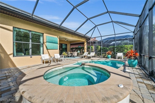 view of swimming pool with a lanai, a patio area, a mountain view, and an in ground hot tub