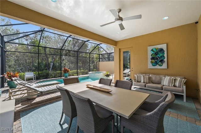 view of patio featuring a lanai, a pool with hot tub, and outdoor lounge area