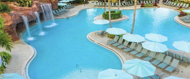 view of swimming pool with pool water feature