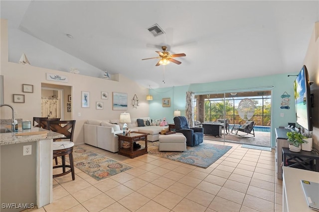 tiled living room featuring ceiling fan, vaulted ceiling, and sink