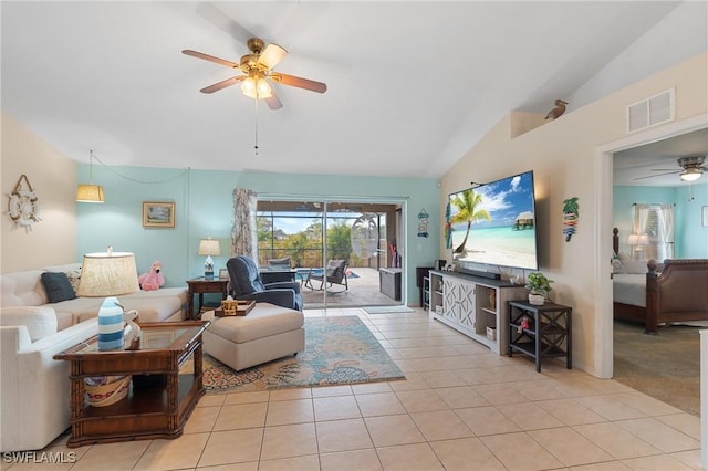 living room featuring vaulted ceiling, ceiling fan, and light tile patterned floors