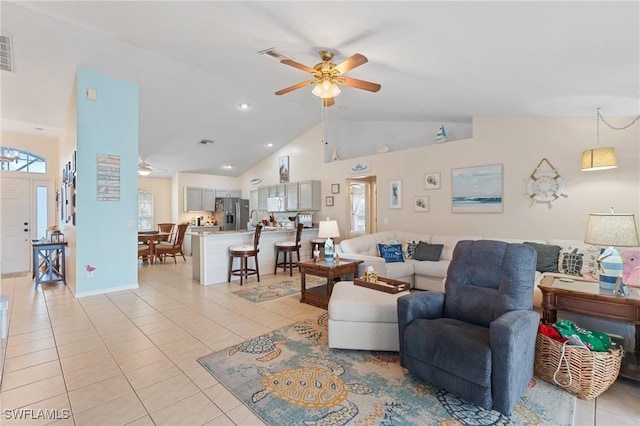 tiled living room with ceiling fan and high vaulted ceiling