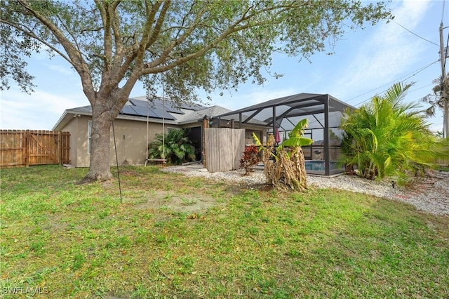 view of yard with glass enclosure