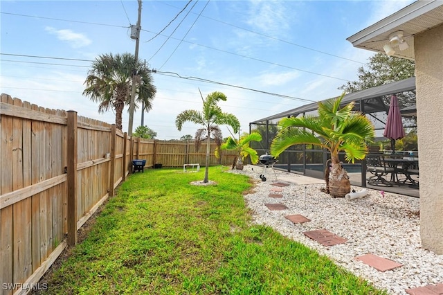 view of yard with a lanai and a patio