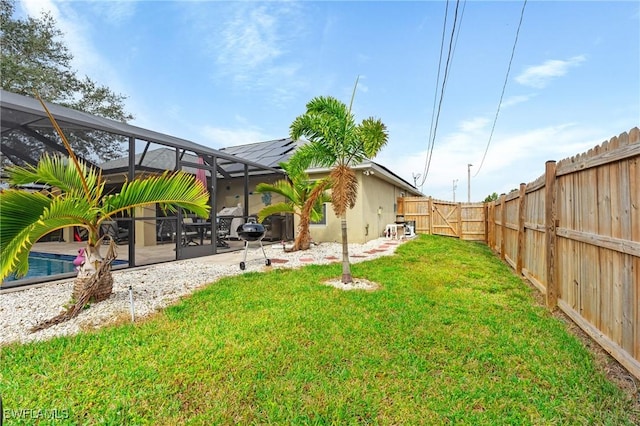 view of yard featuring a lanai, a fenced in pool, and a patio