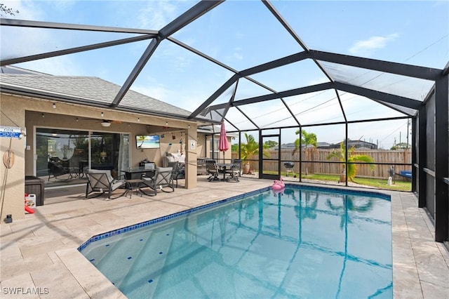 view of pool featuring a patio area, a lanai, and ceiling fan