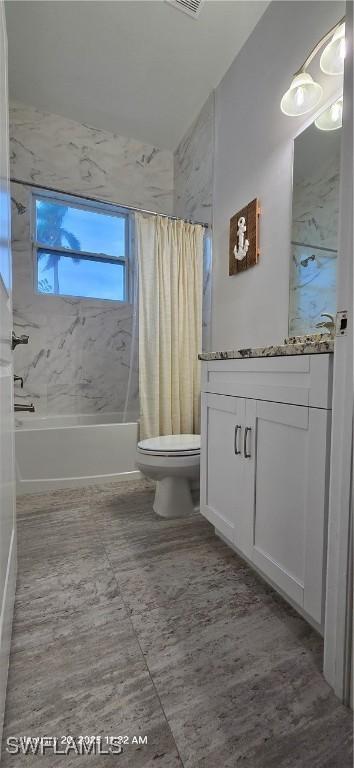 full bathroom featuring toilet, vanity, and shower / tub combo with curtain