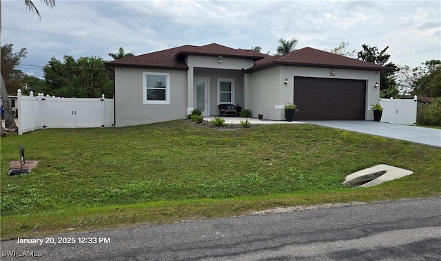 view of front of home with a garage and a front lawn