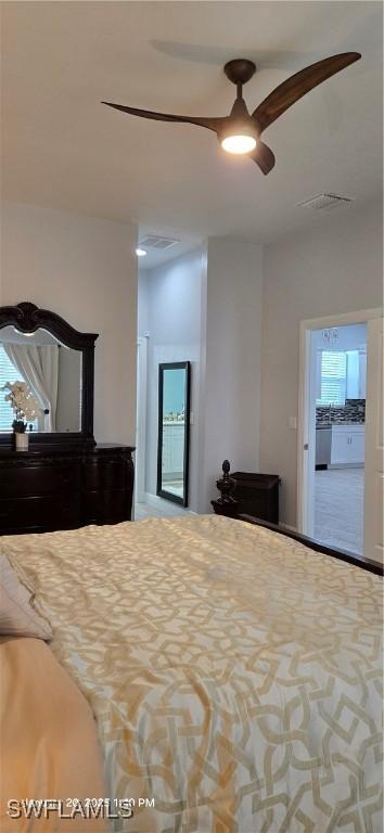 bedroom with ceiling fan and ensuite bath