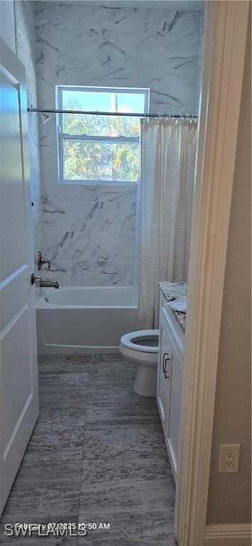 full bathroom featuring shower / bathtub combination with curtain, vanity, and toilet