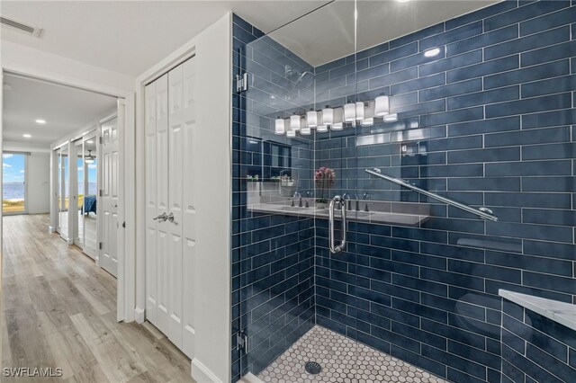 bathroom featuring wood-type flooring and walk in shower