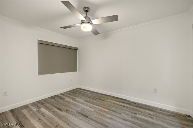 empty room featuring ornamental molding, wood-type flooring, and ceiling fan